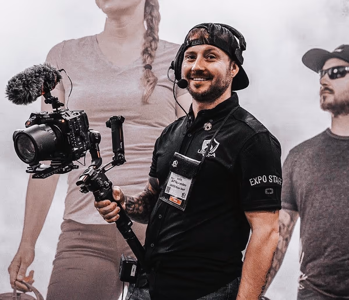 Operator with cinema camera on a gimbal at a live event.